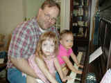 Al, Anna, and Angie at the piano. Now Angie loves the piano.