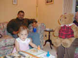Angeline celebrating Thanksgiving 2001 while Uncle Gil watches